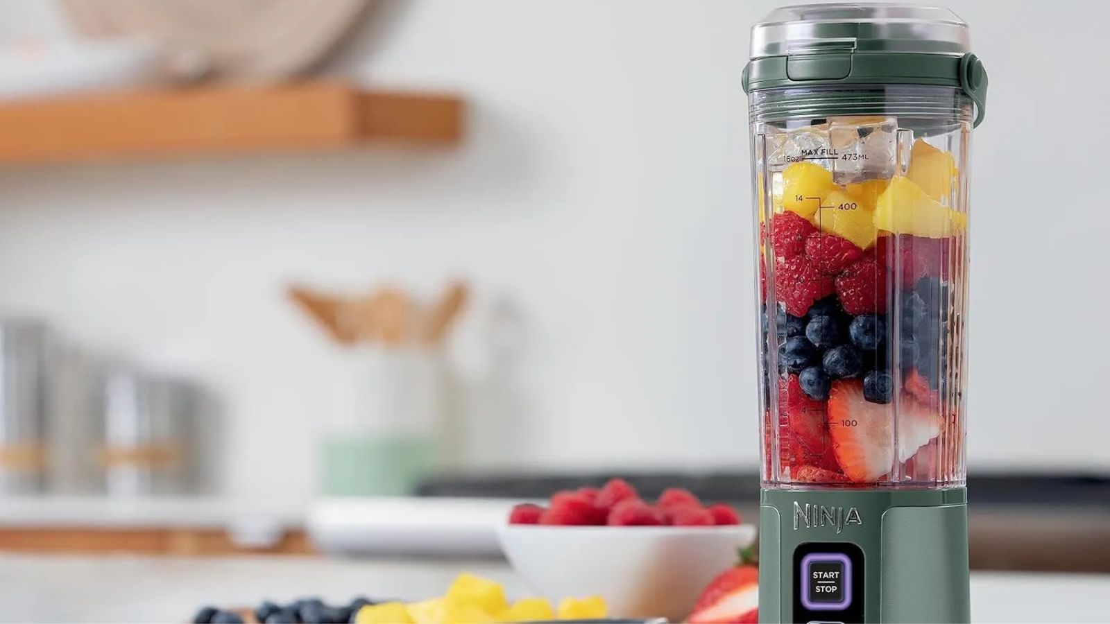 Ninja Blast in pale green blending a fresh fruit smoothie