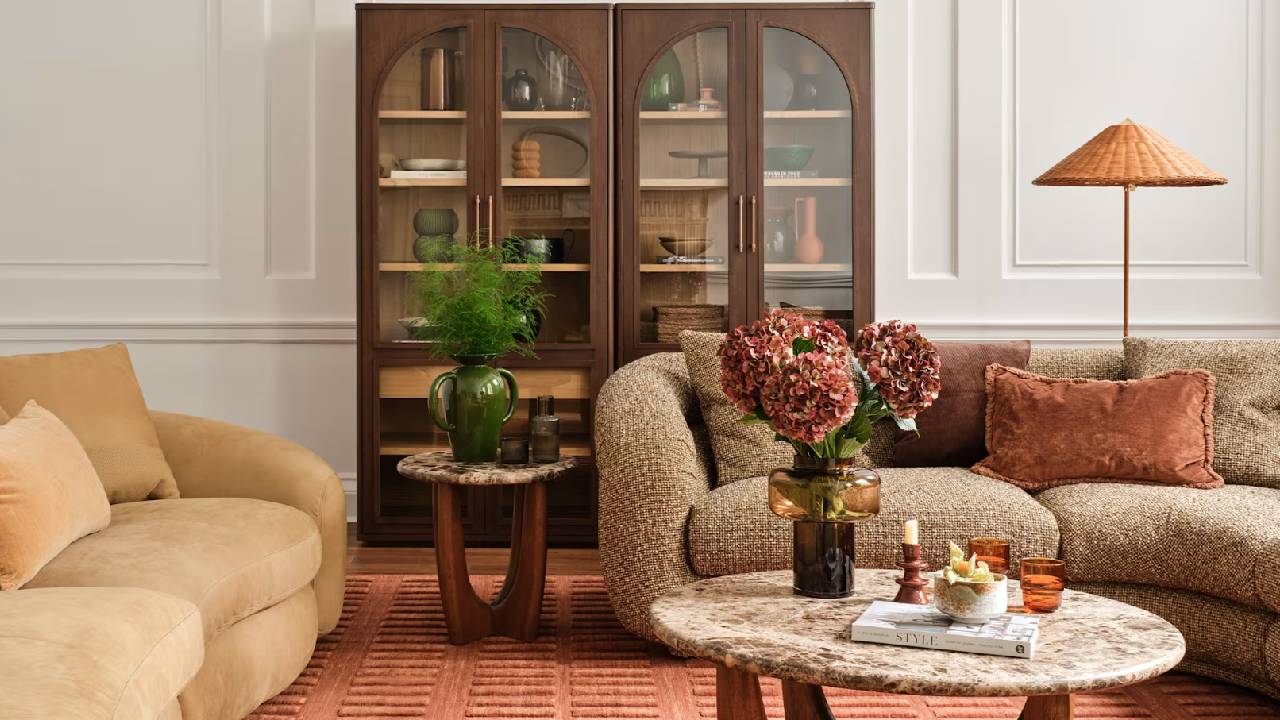 A modern, autumnal coloured lounge with sofas, a coffee table, and a large cabinet from Castlery.