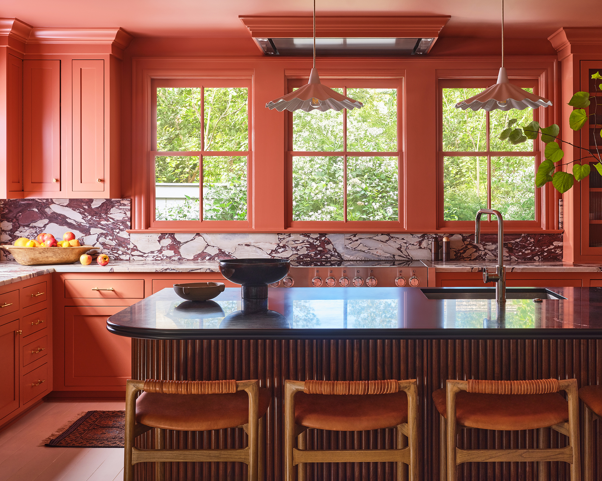 kitchen with pink millwork and dark countertop