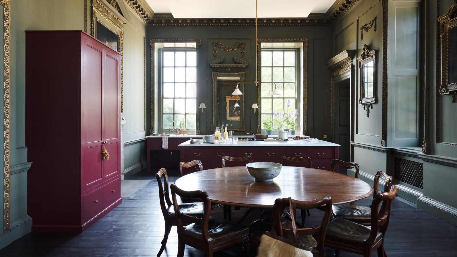 Raynham Hall kitchen with green walls, red cabinetry, and freestanding furniture