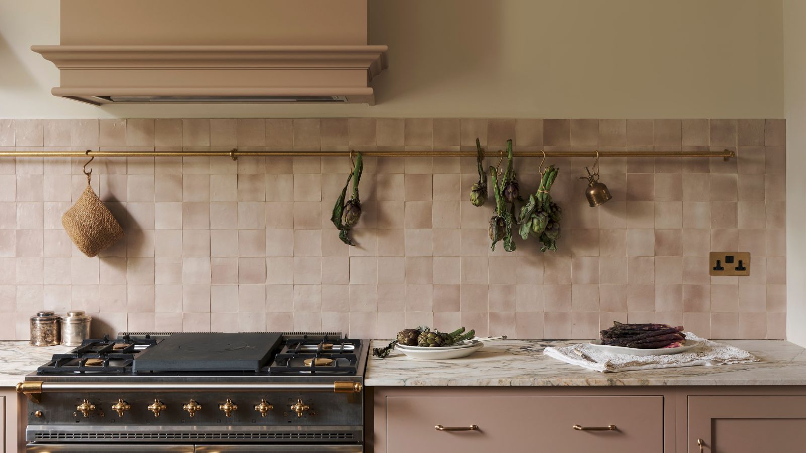 A pink kitchen with a pink square tiles backsplash