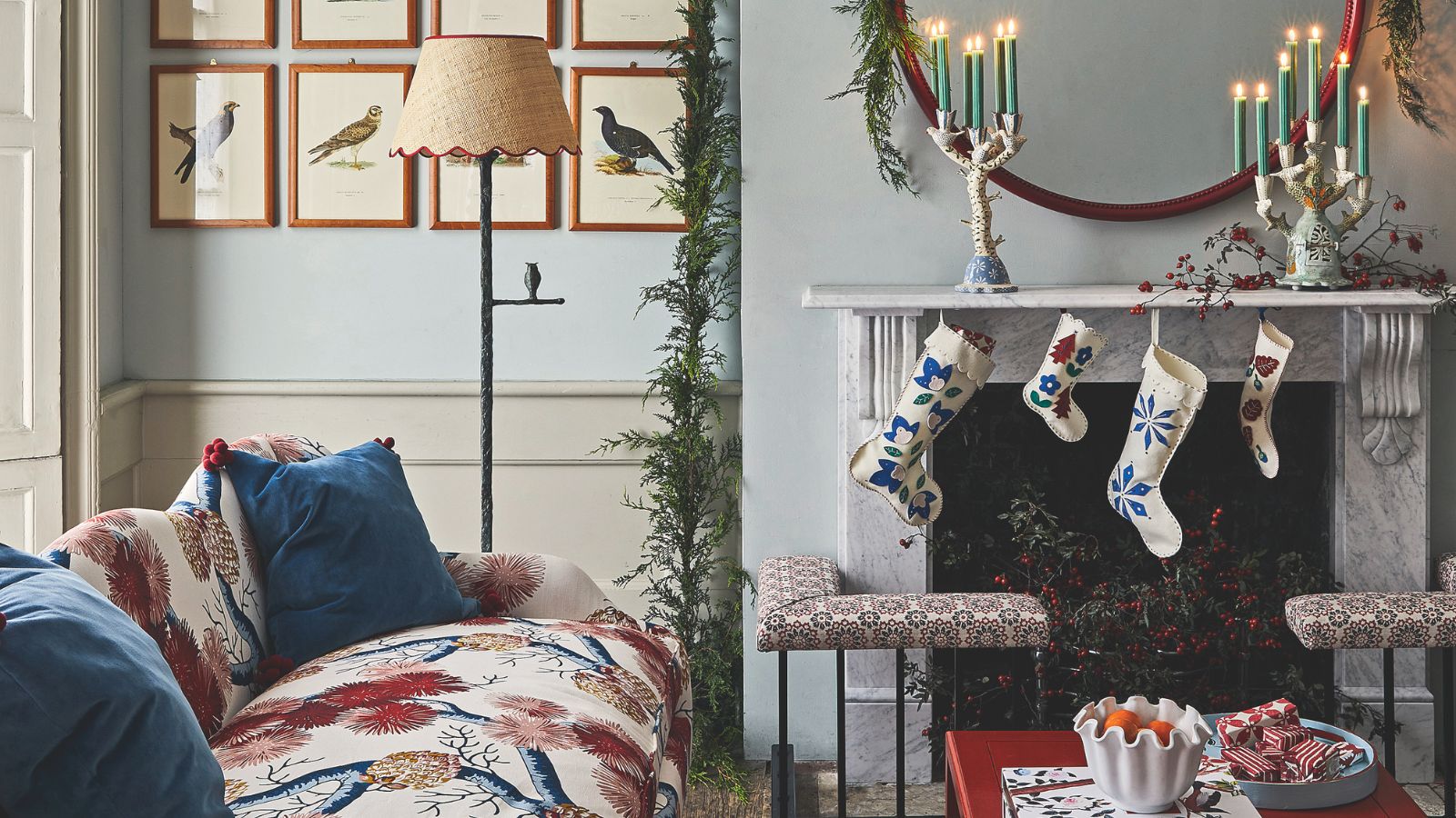 Marble mantel with white and blue felt stockings and white candelabras with green taper candles