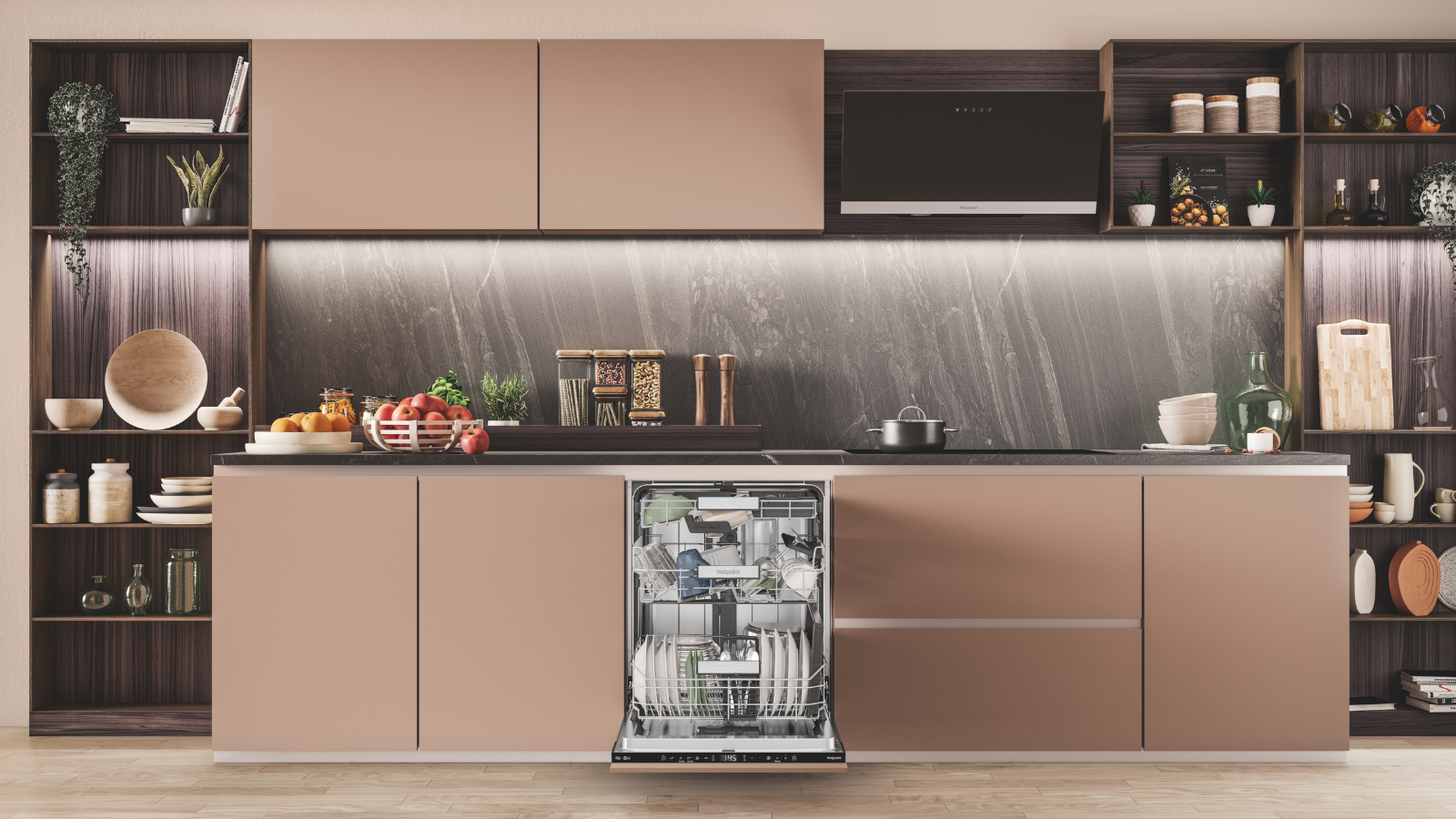 A neutral, modern and stylish kitchen with rose-gold cabinets, a countertop full of miscellaneous kitchen cookware, and an open dishwasher revealing a full, clean load.
